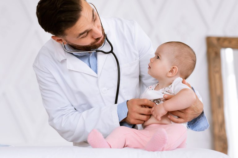 doctor with baby at her six month checkup